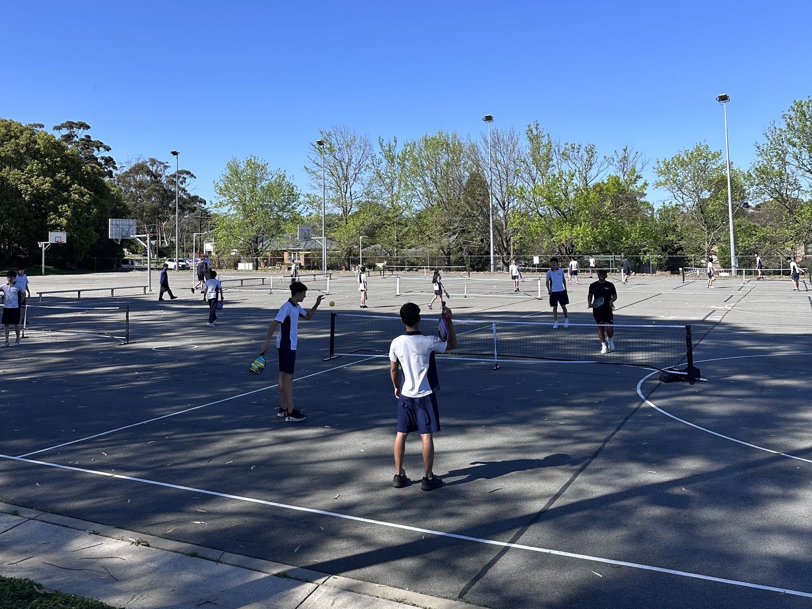 Students playing pickleball on the outdoor courts at Killarney Heights High School